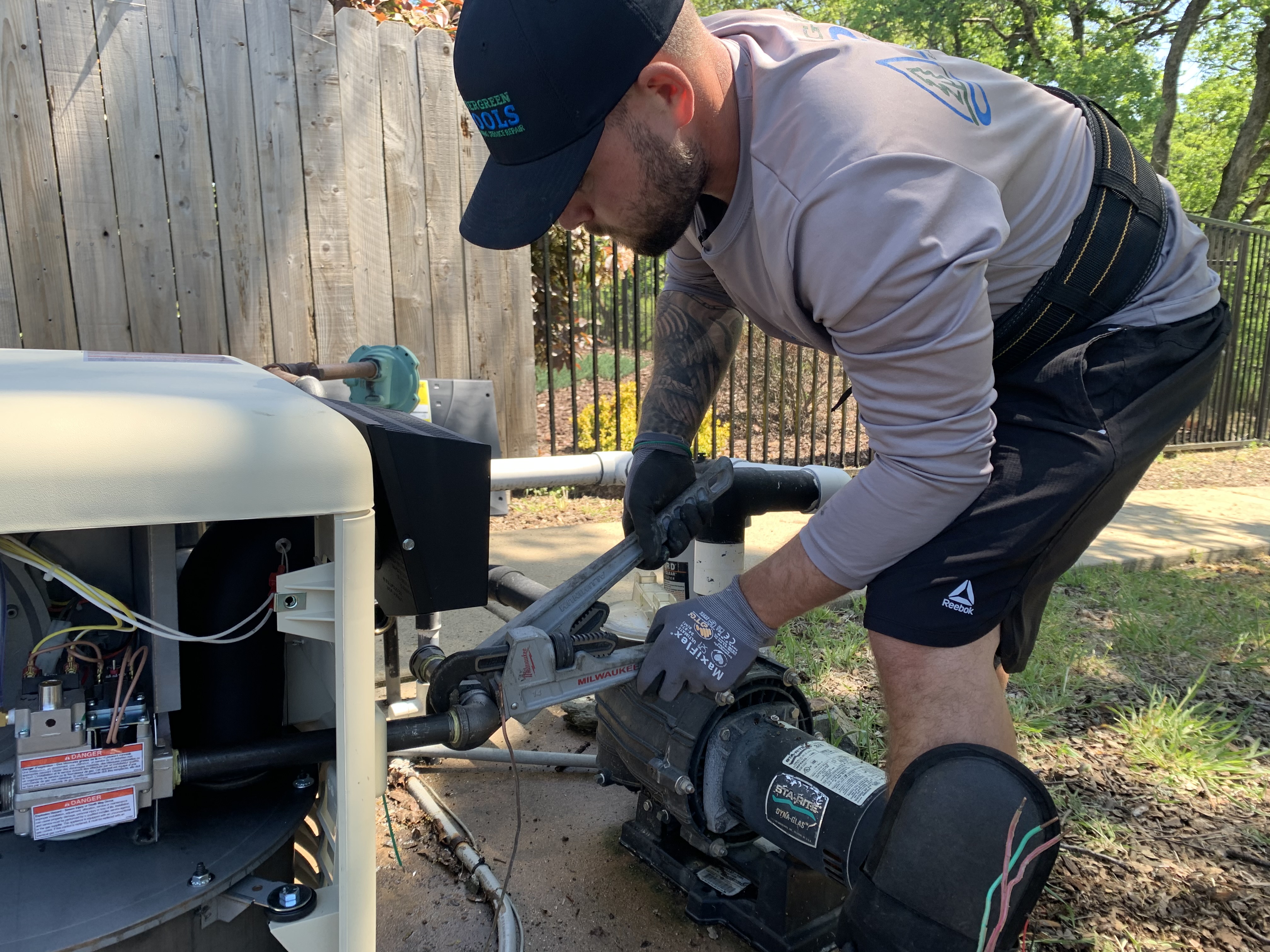 Nevergreen tech servicing pool equipment with hose